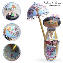 Under the Shade Admiring Sakura  Beautifully embellished wood turned Kokeshi inspired doll. Her umbrella is very embellished it has a wonderful cherry blossom tree on one side the other side has Mt. Fuji with the sun and birds as a backdrop. Sakura are hiding under the umbrella as well! Her dolls signature design are the green eyes.